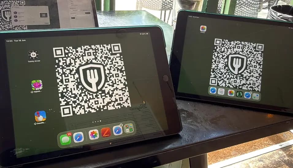 Diners scanning a TrustDiner QR code at the table